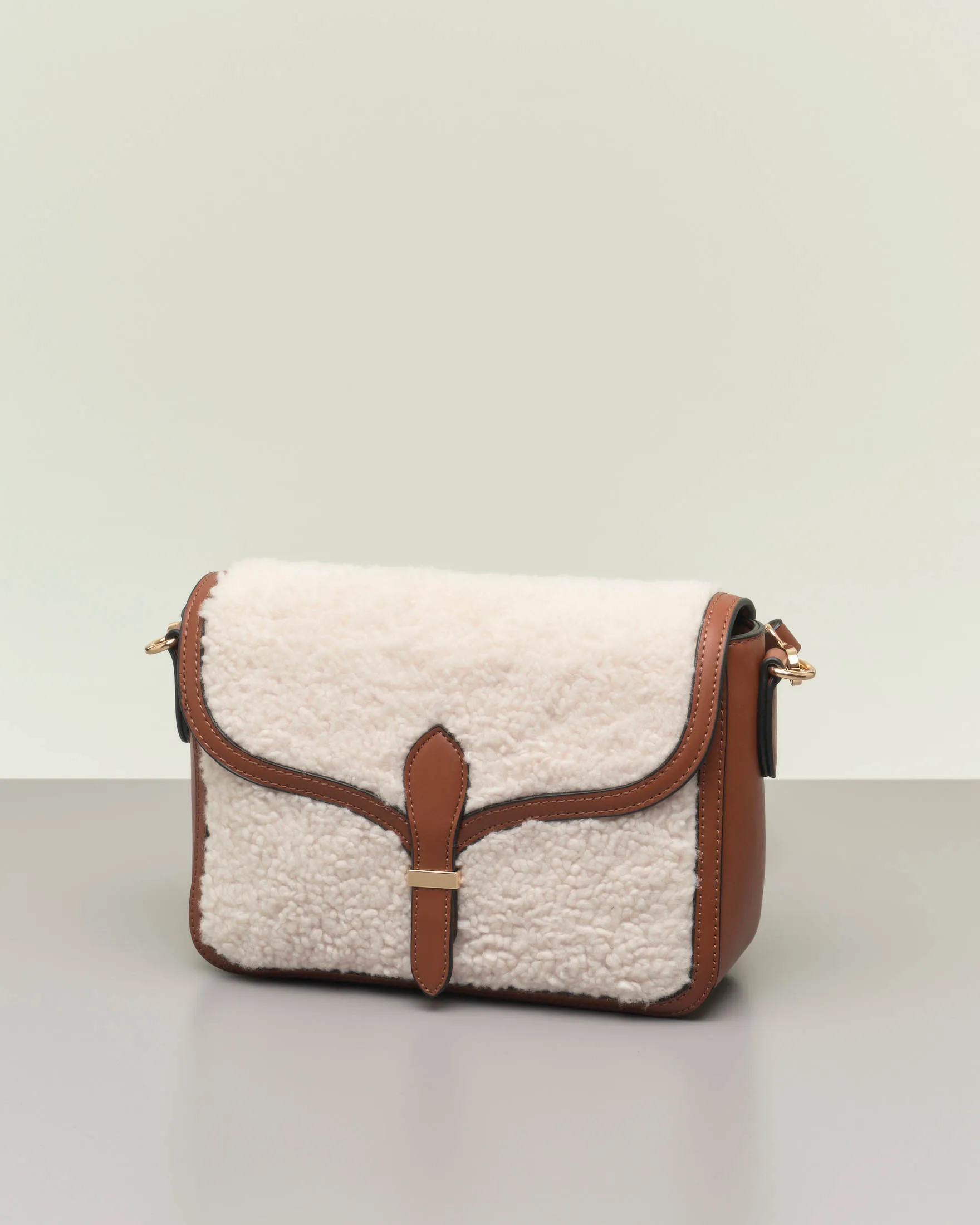 Borsa color cuoio in similpelle liscia con davantino in shearling bianco